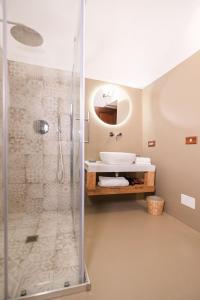 a bathroom with a shower and a sink at Pavì Trulli e Suites in Locorotondo +83 photos