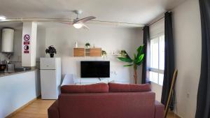 a living room with a couch and a tv at Apartalux Calas Magic in Calasparra