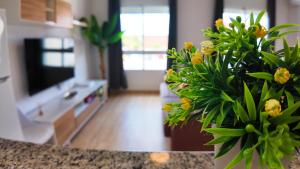 a living room with a vase of flowers on a counter at Apartalux Calas Magic in Calasparra