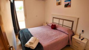 a bedroom with a bed with a red pillow on it at Apartalux Calas Magic in Calasparra