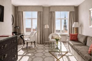 a living room with a couch and chairs and a window at Grand Palace Hotel - Small Luxury Hotels of the World in Riga