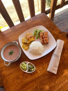 a plate of food with rice and vegetables on a table at La Cima Bachué in Ubaque