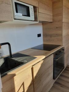a small kitchen with a sink and a microwave at Corsappart in Porto-Vecchio +22 photos