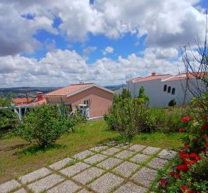 a view of a house from a garden at Campo de Oleandros in Lourinhã