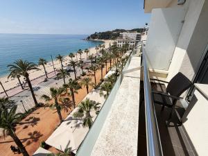 a balcony with a view of a beach and the ocean at Hotel Excelsior in Lloret de Mar +15 photos
