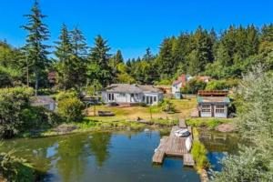 an aerial view of a house with a pond at Eagle Harbor House World Cup Availability in Winslow