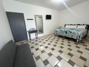 a bedroom with a bed and a tiled floor at Hotel Posada La Catrina in Ciudad Fernández