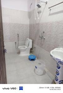 a bathroom with a toilet and a sink at Shaaneshwar Mahadev Hotel & Restaurant in Phata