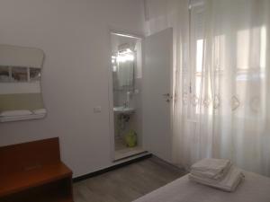 a white bathroom with a shower and a sink at Affittacamere La Spezia Inn in La Spezia +42 photos