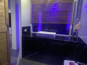 a bathroom with a sink and a window with purple lighting at Ocean View Tuggi Klong Prao in Klong Prao Beach +14 photos