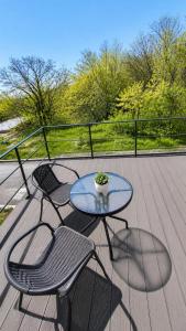 a patio with a table and two chairs on a deck at Apartament Vila Draghici Eforie Sud in Eforie Sud