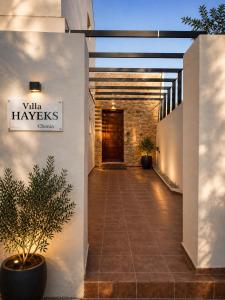 a hallway of a building with a sign that reads villa haveleys at Hayeks Villa private pool near the beach in Daratso