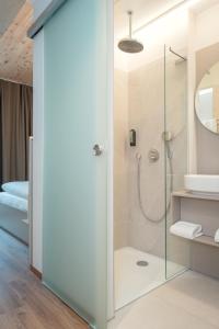 a bathroom with a shower and a sink at RELAXANS Hotel in Dinkelsbühl +24 photos