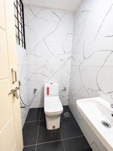a bathroom with a toilet and a sink at Classic Comfort in Chikmagalūr