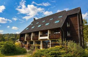 a large house with a gambrel roof at Residence L'Horizon in Murat-le-Quaire