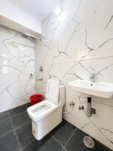 a bathroom with a toilet and a sink at Classic Comfort in Chikmagalūr