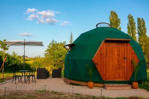 a green dome tent with a table and chairs at Le Havre de Chaux in La Bretenière +18 photos