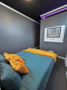 a bedroom with a bed with a yellow blanket on it at MaxiMar Apartment With Sauna in Valga