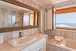 a bathroom with a sink and a mirror at Casa Pôr do Sal - Boutique Suites, Sea Views & Heated Pool in Luz