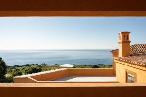 a view of the ocean from the balcony of a house at Casa Pôr do Sal - Boutique Suites, Sea Views & Heated Pool in Luz +88 photos
