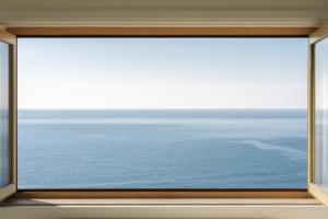 a window with a view of the ocean at Casa Pôr do Sal - Boutique Suites, Sea Views & Heated Pool in Luz