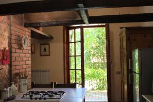 a kitchen with a stove top oven next to a window at CasaLalla - Natura&Relax in Cusano Mutri