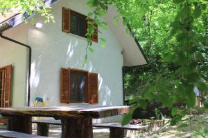 a house with a wooden bench in front of it at CasaLalla - Natura&Relax in Cusano Mutri