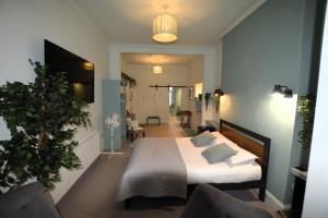 a bedroom with a bed and a living room at Crescent House in Plymouth