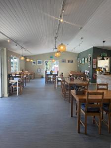 a dining room with wooden tables and chairs at The House at Glenbarr Stores in Glenbarr