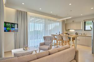 a living room with a couch and a table at Arillas Villas in Arillas