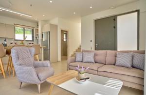 a living room with a couch and a table at Arillas Villas in Arillas