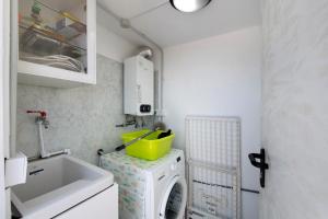 a small kitchen with a washing machine and a sink at vv Rincón Solaris in Tijarafe +19 photos
