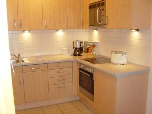a kitchen with a sink and a stove top oven at Ferienwohnung Bartels in Petersdorf mit Terrasse in Fehmarn