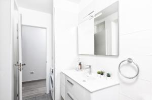 a white bathroom with a sink and a mirror at vv Cerca Nueva in Las Manchas +27 photos