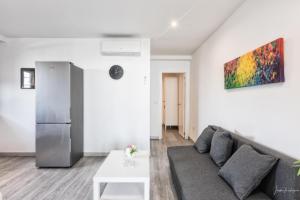 a living room with a couch and a refrigerator at vv Cerca Nueva in Las Manchas