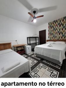 a room with two beds and a ceiling fan at Pousada Capão Fôrro in São Roque de Minas +34 photos