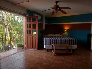 a bedroom with a bed and a ceiling fan at Don Pablo bed and breackfast in Copán Ruinas
