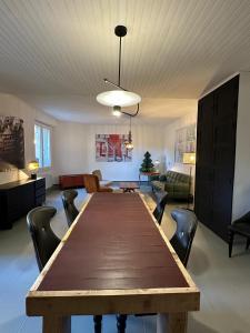 a dining room and living room with a table and chairs at Another World Village house in Buis-les-Baronnies