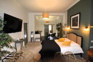 a bedroom with a bed and a living room at Crescent House in Plymouth