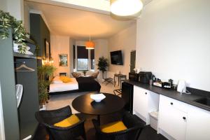 a living room with a couch and a table in a room at Crescent House in Plymouth