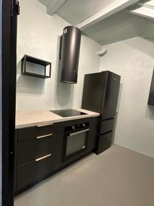 a kitchen with a stove and a refrigerator at Another World Village house in Buis-les-Baronnies +18 photos