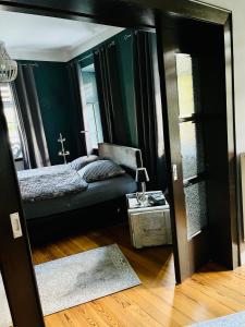 a mirror in a room with a bed and a couch at Casa Hauth in Bernkastel-Kues