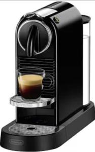 a black coffee maker with a cup of coffee at Ferienwohnung im Geyserhof in Gau-Bischofsheim +10 photos