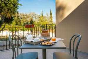 a table with a basket of food and orange juice at Baglio Làuria in Campobello di Licata