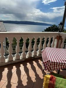 a white railing on a balcony overlooking the water at Apartments & Room MaDi in Senj +87 photos