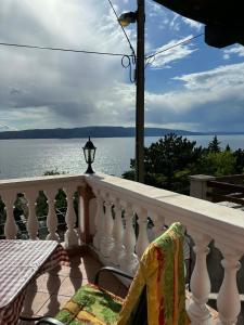 a balcony with a view of the water at Apartments & Room MaDi in Senj