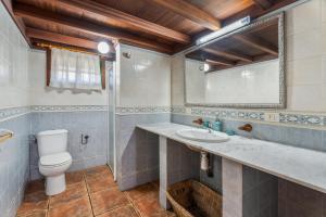 a bathroom with a toilet and a sink at vv Casa Rural El Pajar in El Pinar del Hierro +18 photos