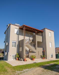 a building with stairs on the side of it at La Marine Apartments in Kalandra