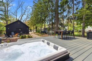 a hot tub on a deck with a table and chairs at Sunset on Pokagon in Michiana