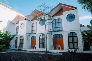 a house with an orange and white at D'Muarra Studio Villa in Cemagi